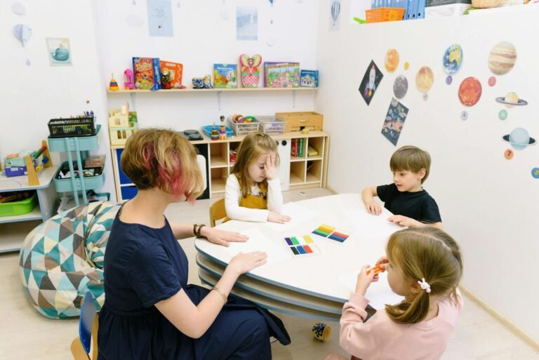 Children engage in a colorful activity with a teacher in a bright kindergarten classroom.